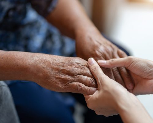 Hand of elderly woman holding hand younger woman, Helping hands, take care for the elderly concept.